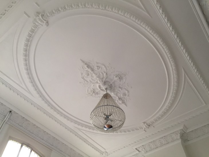 Detail of the ceiling medallion and crystal chandelier in the prenatal practice room.